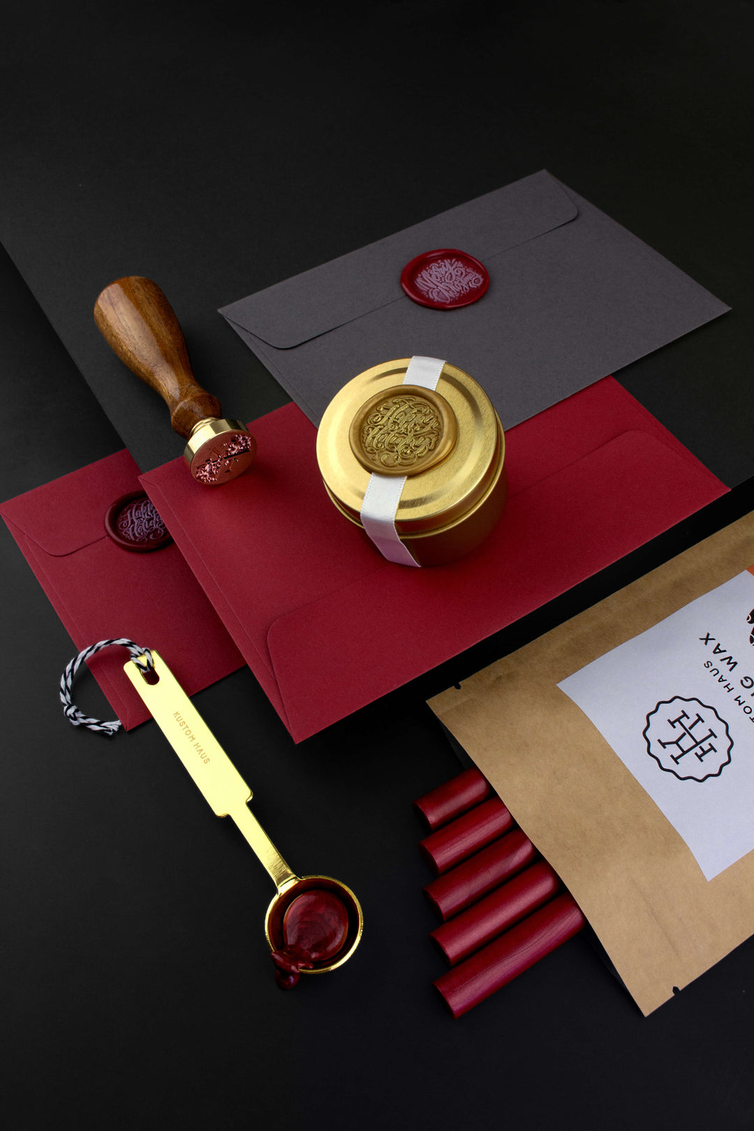 Christmas Wax Seal Stationery with a Gold Melting Spoon, Gold Candle, Red Envelopes and Red Sealing Wax. Features a Wax Seal Stamp with Turned Wooden Handle and Brass Die.